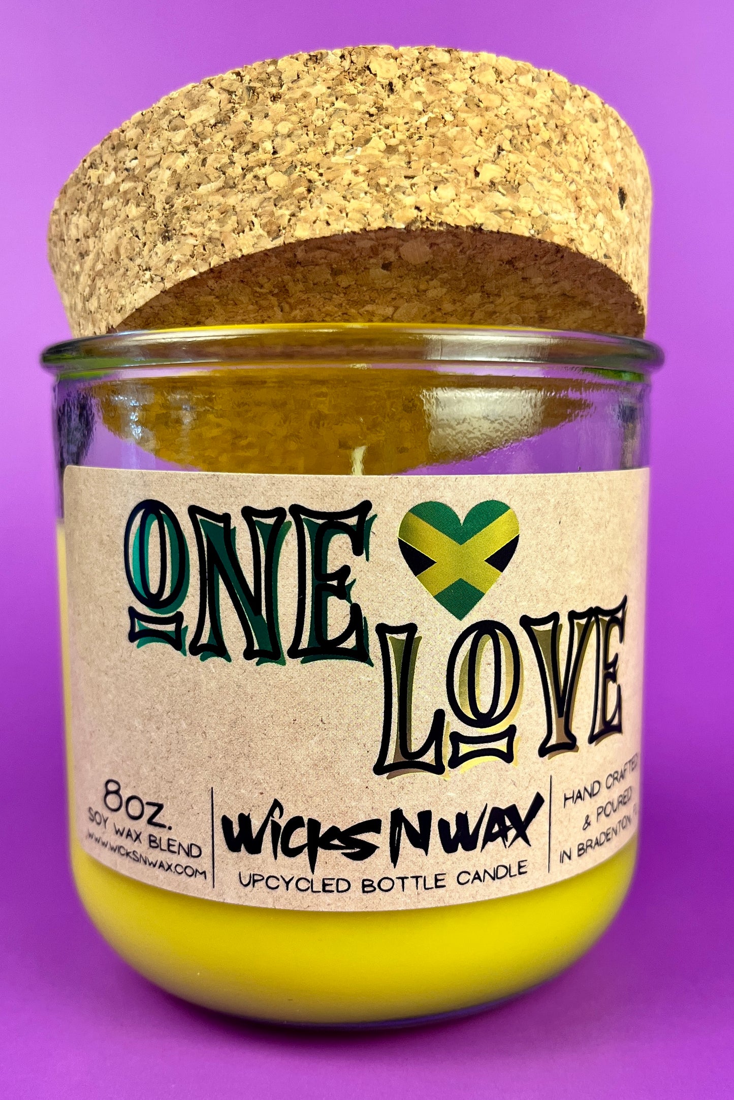 Recycled glass candle jar with cork backing, yellow wax, One Love label.