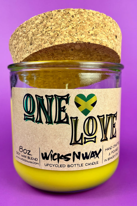 Recycled glass candle jar with cork backing, yellow wax, One Love label.
