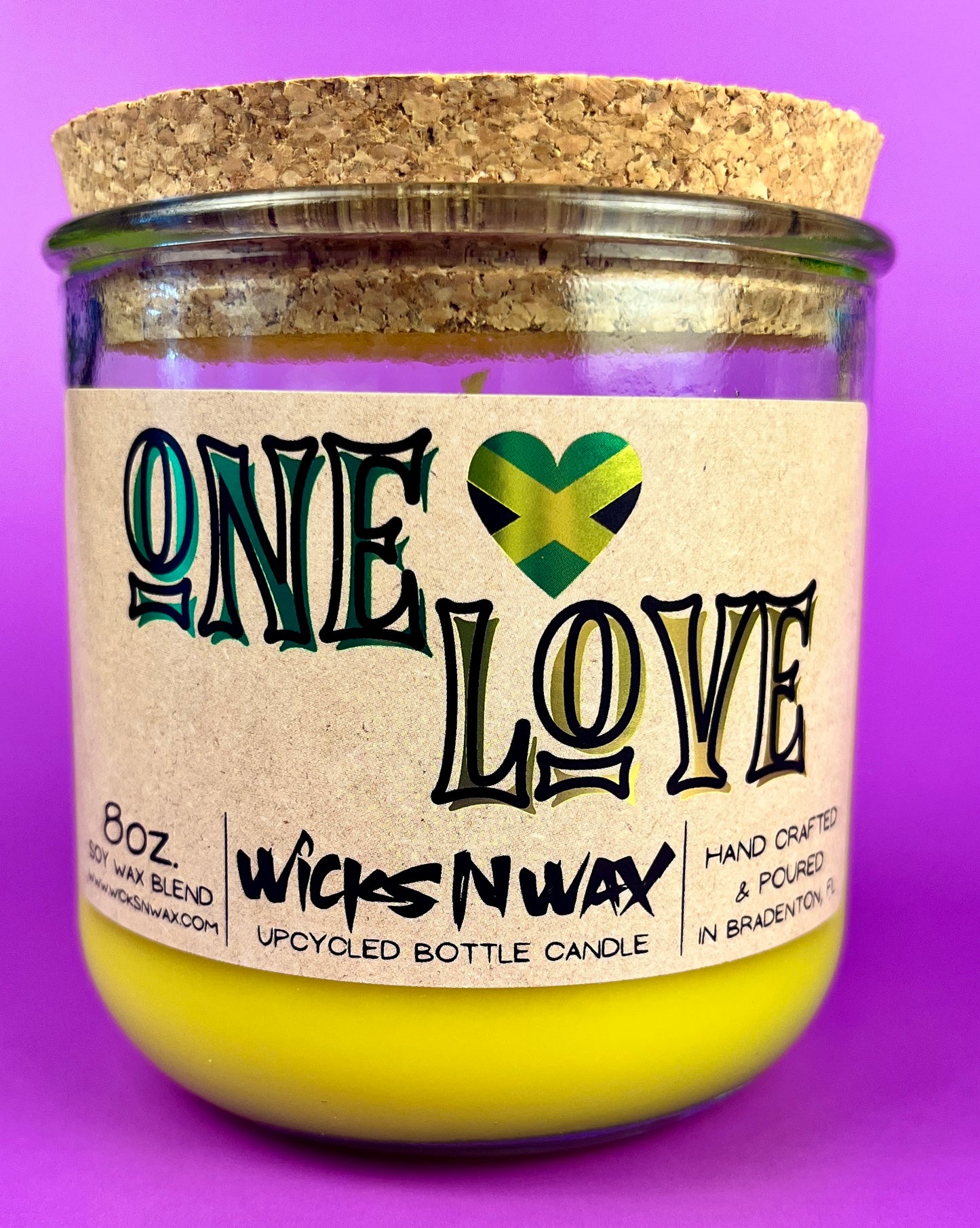 Recycled glass candle jar with cork base, yellow wax, One Love label.