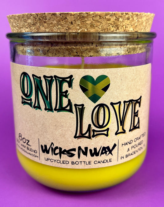 Recycled glass candle jar with cork base, yellow wax, One Love label.