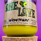 Recycled glass candle with amber jar and cork base, yellow wax, One Love label.