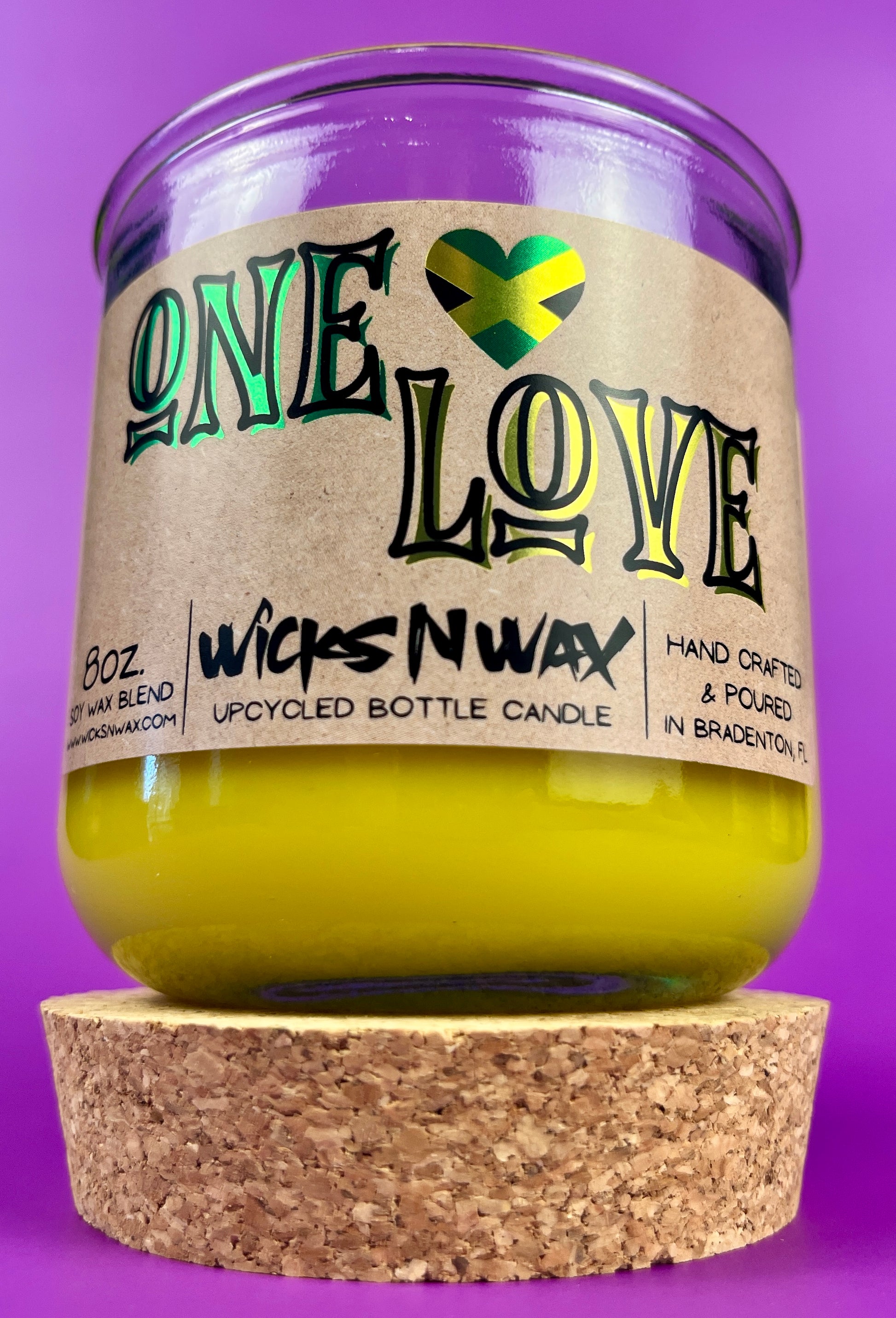Recycled glass candle with amber jar and cork base, yellow wax, One Love label.