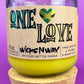 Recycled glass candle in amber jar with cork base, yellow wax, One Love label.