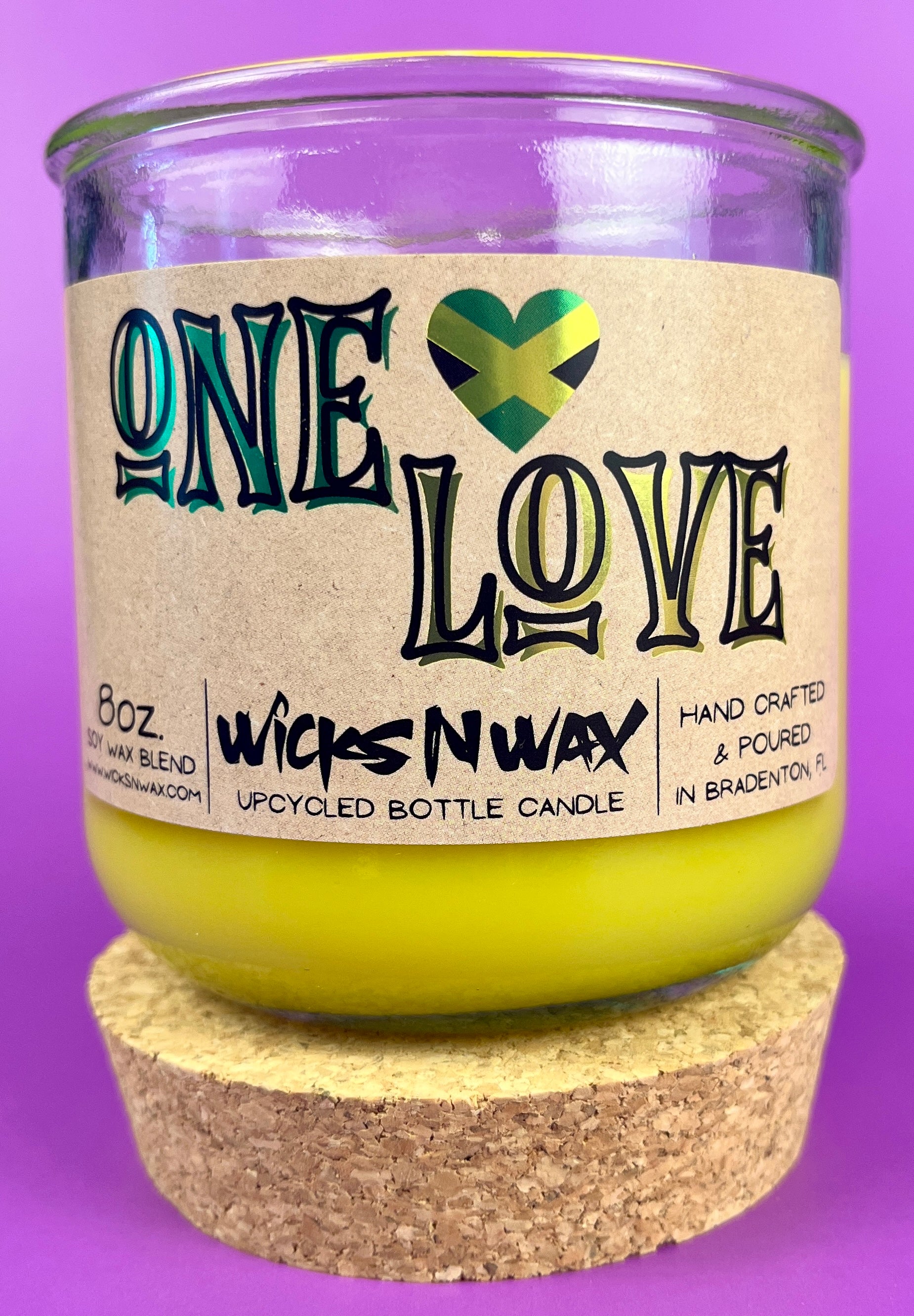 Recycled glass candle in amber jar with cork base, yellow wax, One Love label.