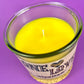 Recycled glass candle top view with yellow wax and centered wick.