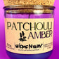 Recycled glass candle in clear jar with purple wax and cork lid, front label.
