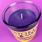 Recycled glass candle with purple wax surface and centered wick in clear jar.