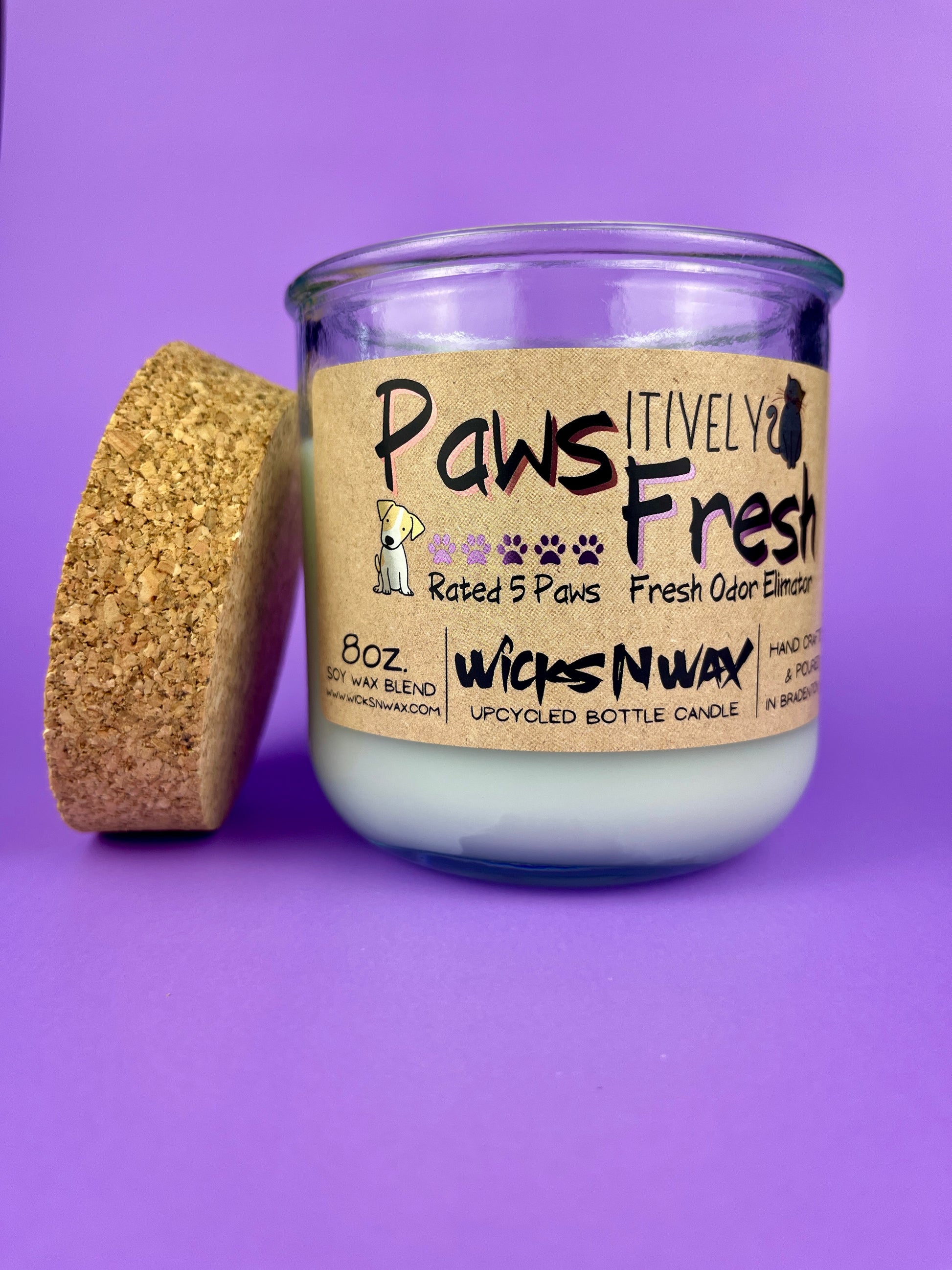 Recycled bottle candle with cork stopper and white wax, front label visible