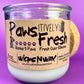 Recycled glass candle with white wax and cork lid, close-up of paw-themed label
