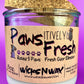 Recycled glass candle with white wax and cork lid, close view of paw-themed label