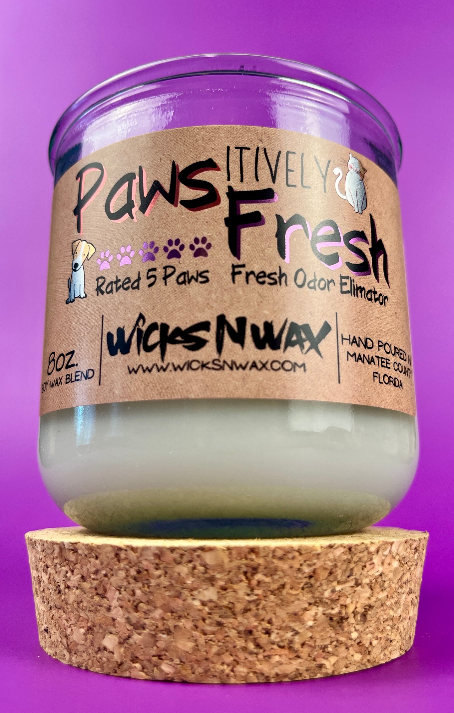 Recycled glass candle with white wax and cork base, label with paw and “Fresh” text