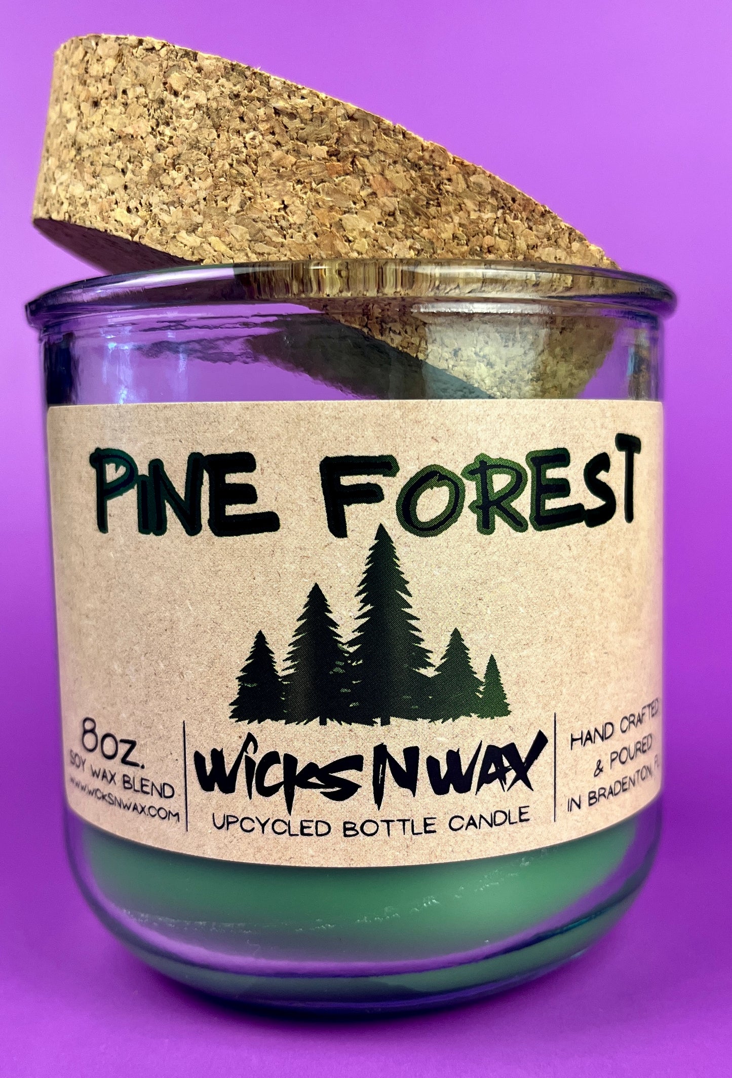 Pine Forest recycled bottle candle in clear glass jar with green wax, cork top