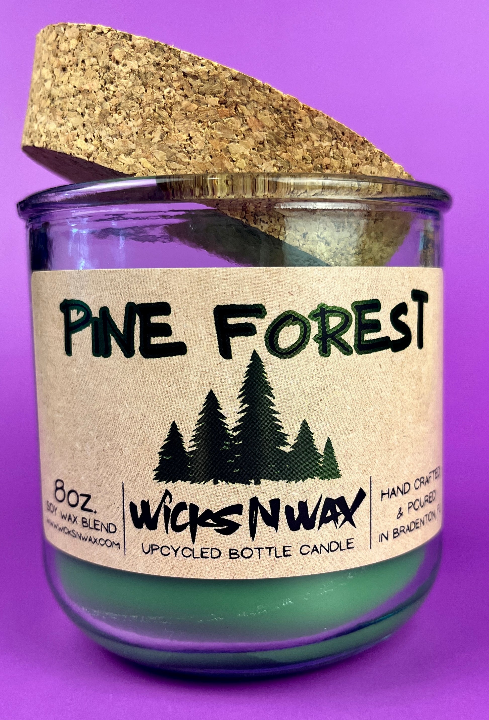 Pine Forest recycled bottle candle in clear glass jar with green wax, cork top