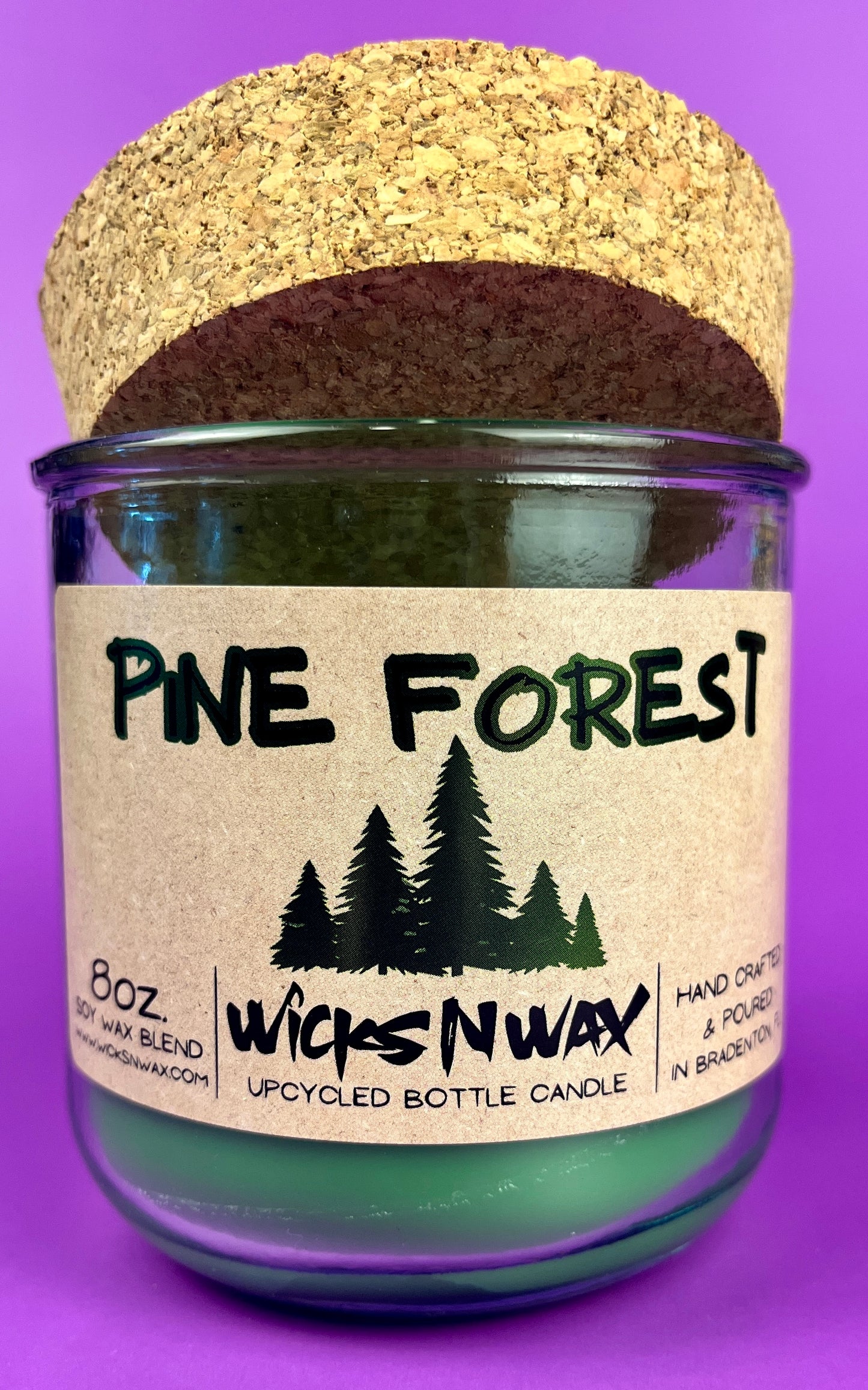 Pine Forest recycled glass candle jar with green wax and front label, cork base