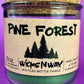 Recycled glass candle in a jar with “Pine Forest” pine tree label and cork lid