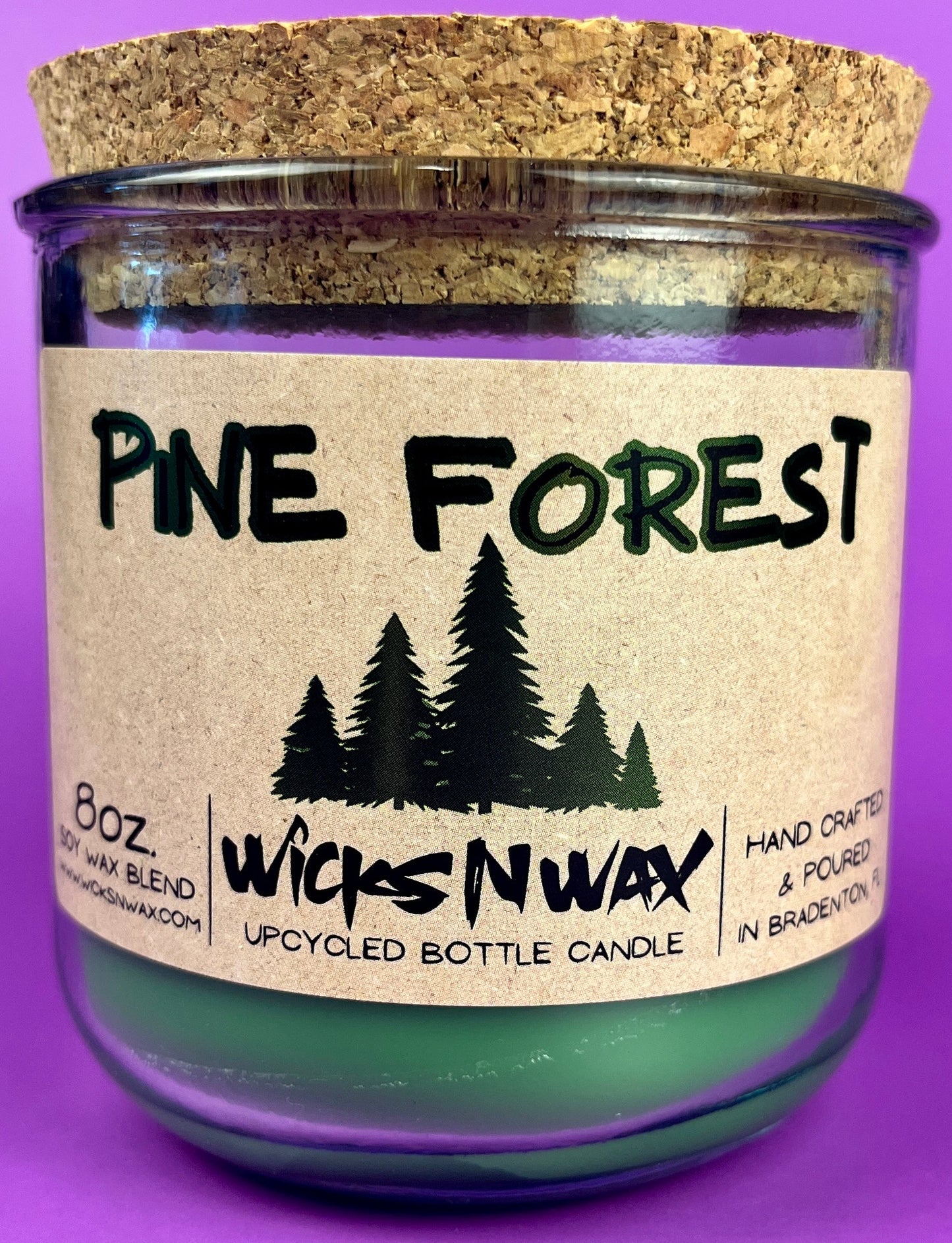 Recycled glass candle in a jar with “Pine Forest” pine tree label and cork lid