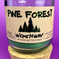 Pine Forest WicksNWax upcycled bottle candle in clear glass jar, green wax level