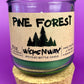 Pine Forest recycled glass candle jar with green wax and cork base, front label