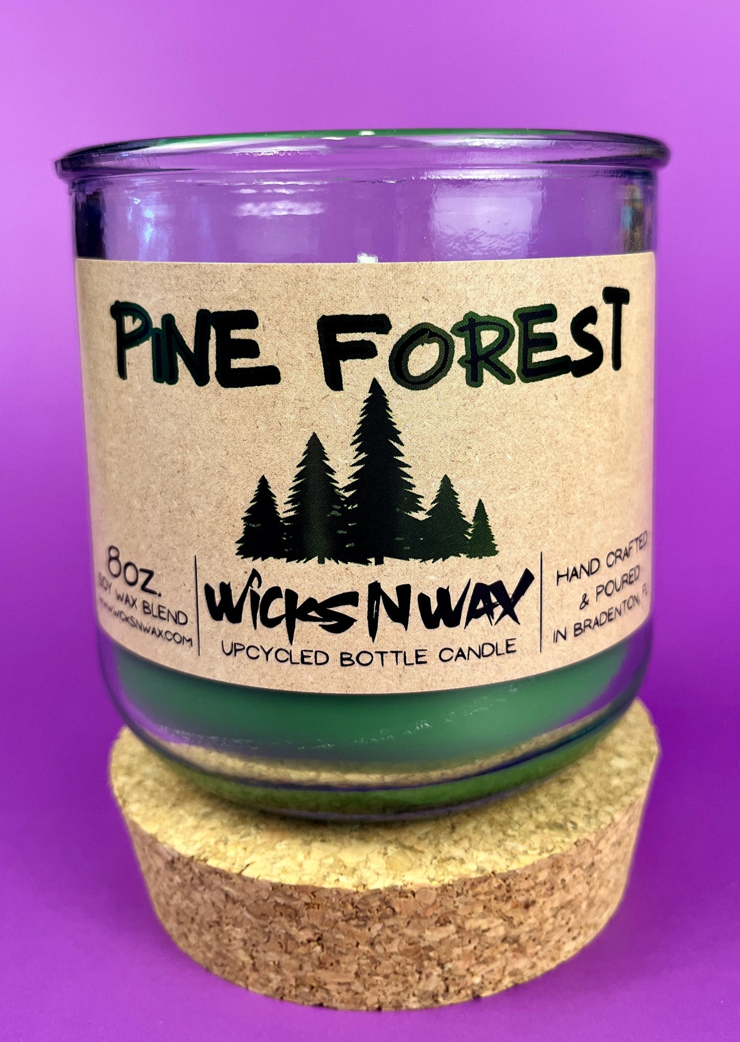 Pine Forest recycled glass candle jar with green wax and cork base, front label