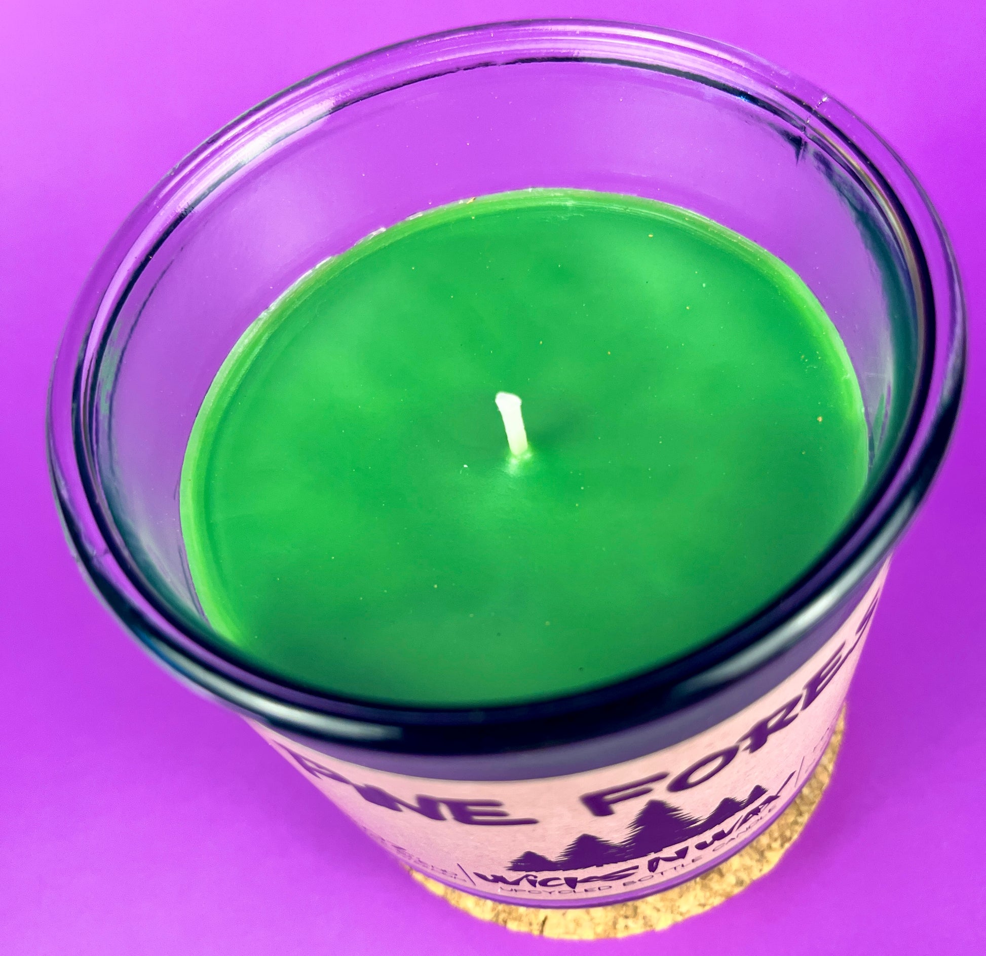 Pine Forest candle in clear glass jar with green wax and visible wick