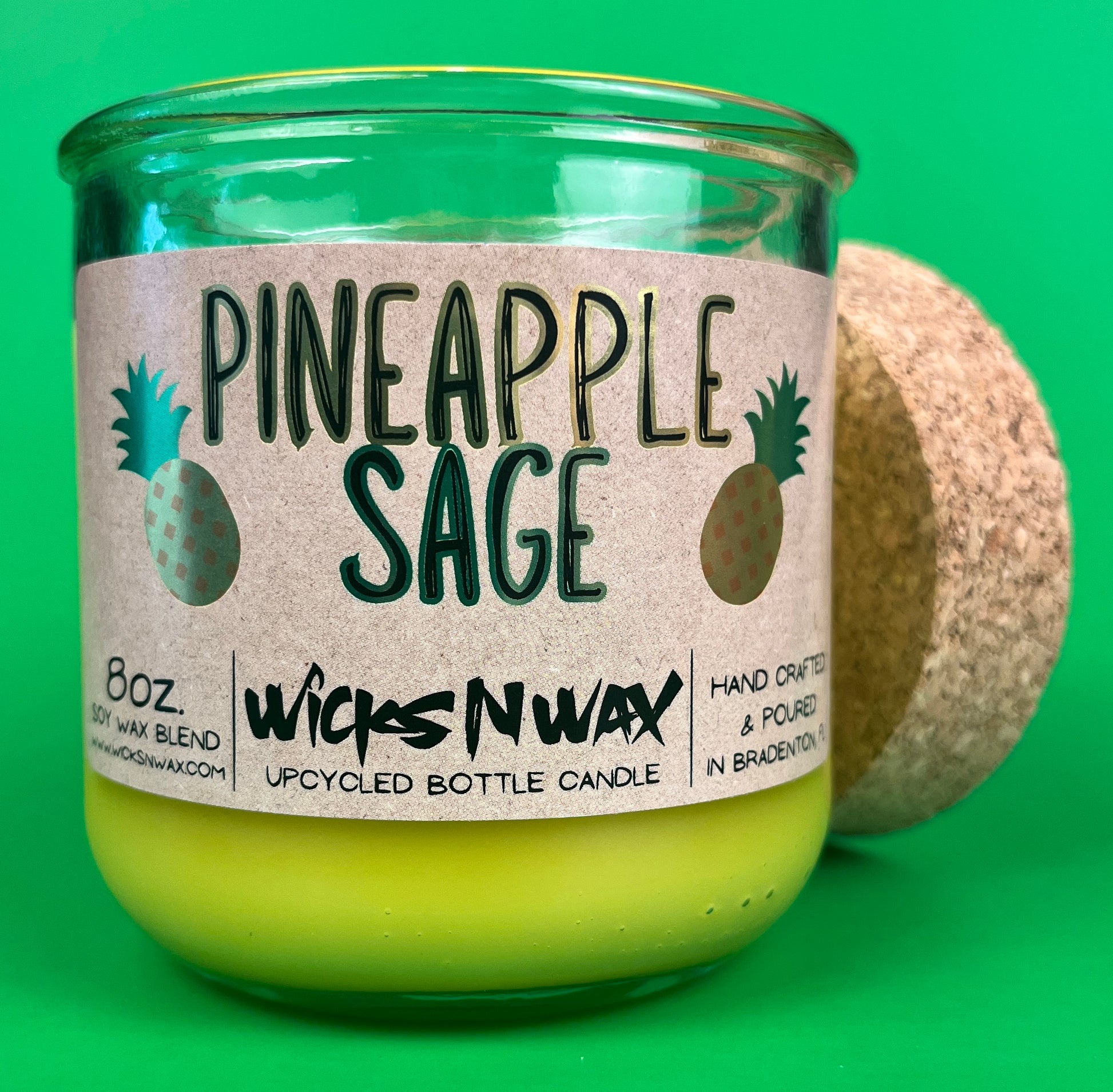 Pineapple Sage recycled bottle candle with cork base, green glass jar, and yellow wax