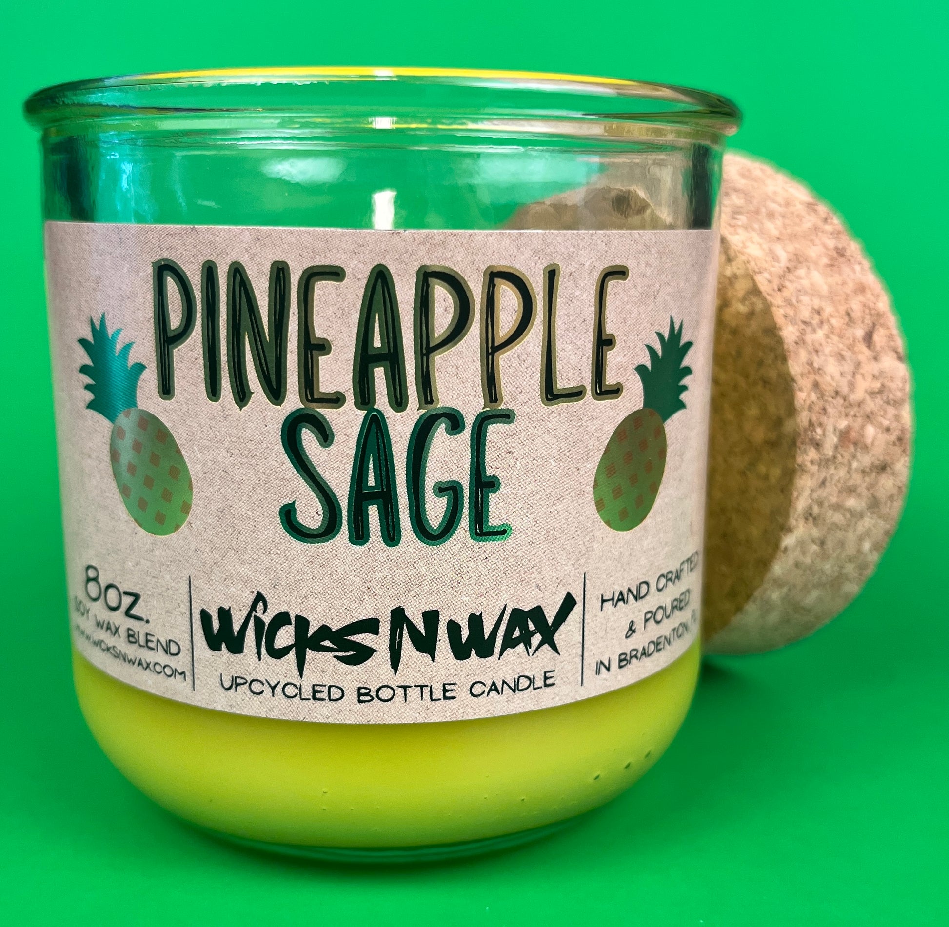 Pineapple Sage recycled glass candle, cork lid and label on green glass jar with yellow wax