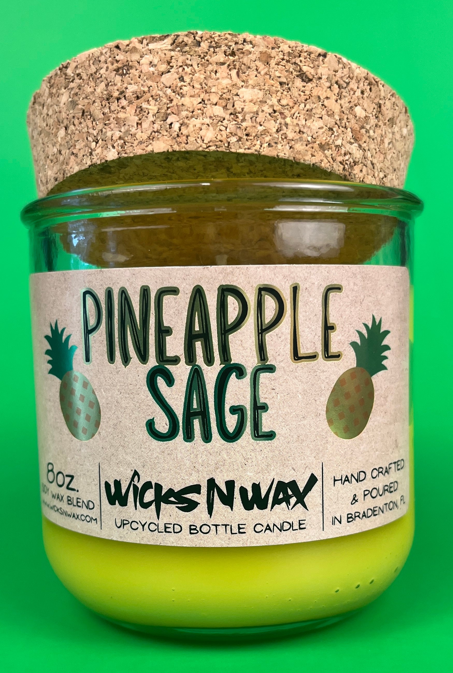 Pineapple Sage recycled glass candle with cork lid and lime-yellow wax in green jar