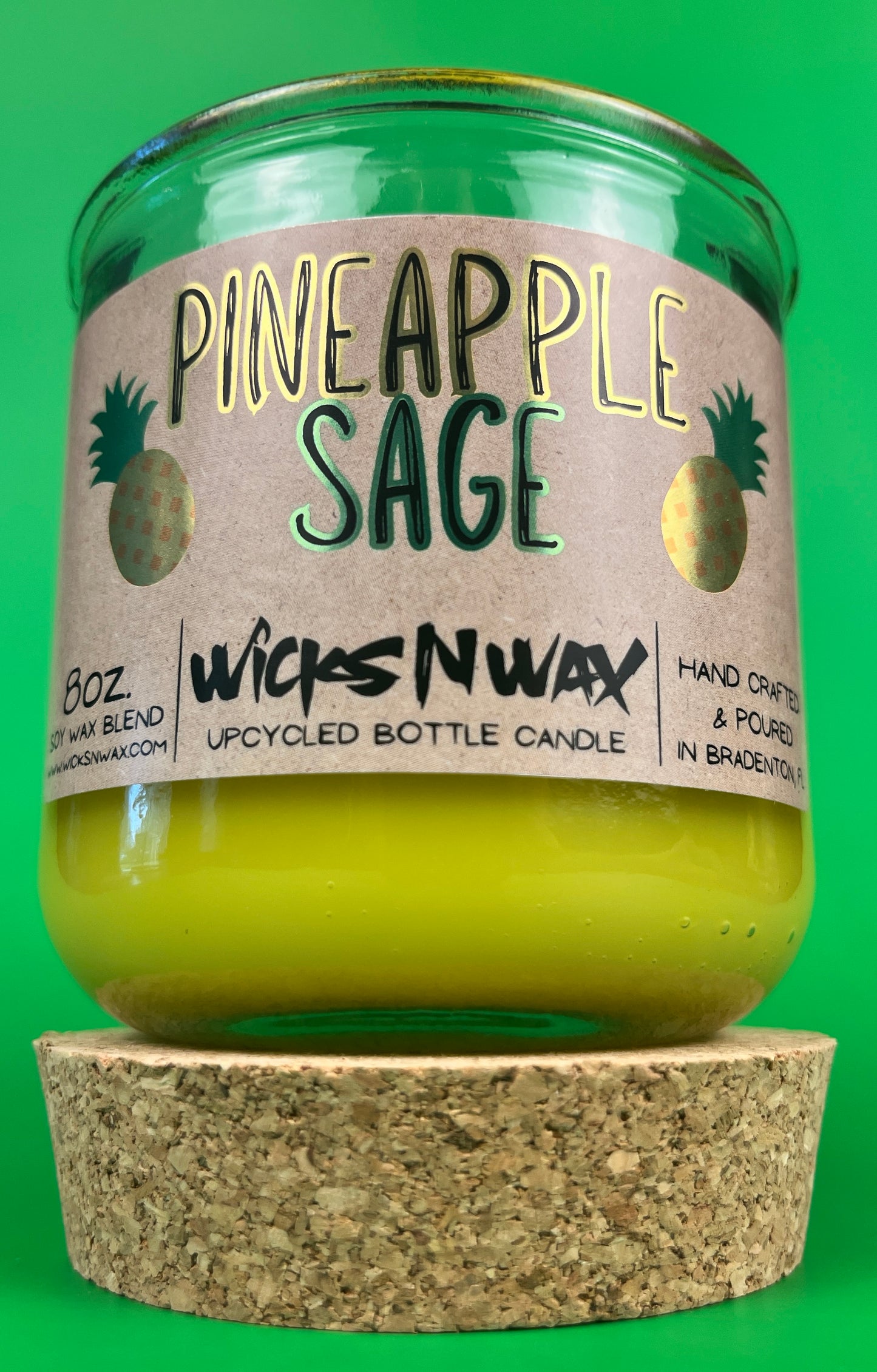 Pineapple Sage recycled glass candle with green glass jar and cork base, yellow wax at bottom