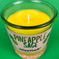 Pineapple Sage recycled glass candle with lit wick and yellow wax inside clear green jar