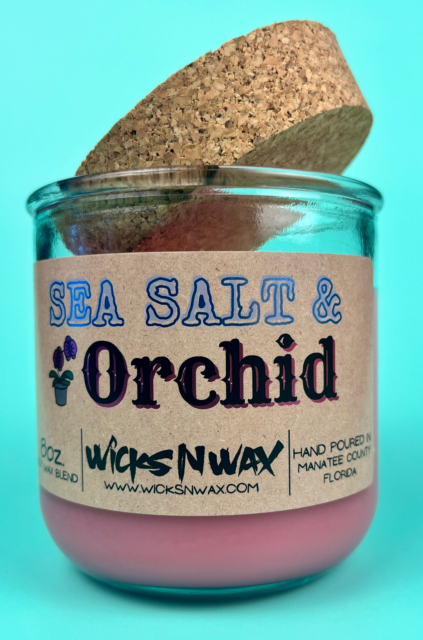 Recycled glass candle with cork lid, pink wax, blue-and-black printed label