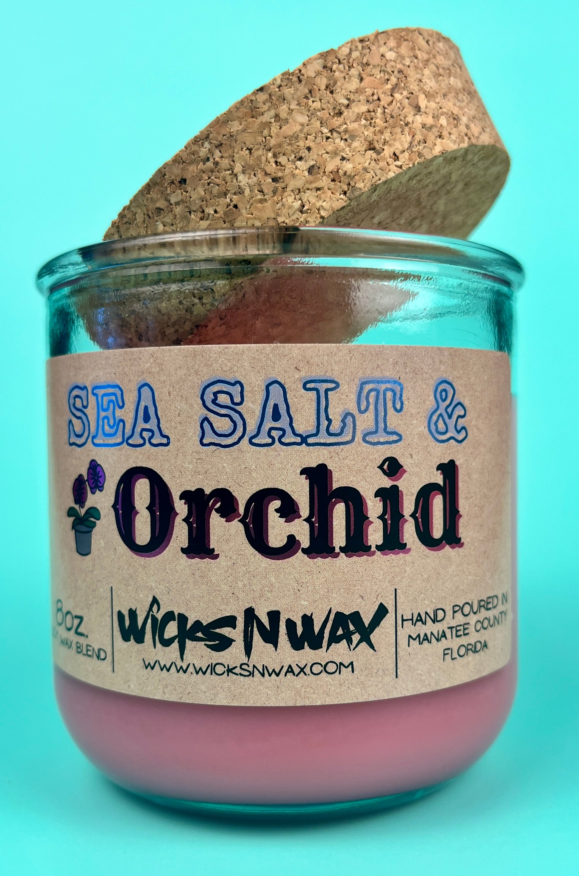 Recycled glass candle with cork lid, pink wax, blue-and-black printed label