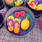 Small WicksNWax sea art tin with blue wax melts, pink tentacle, and pineapple pieces