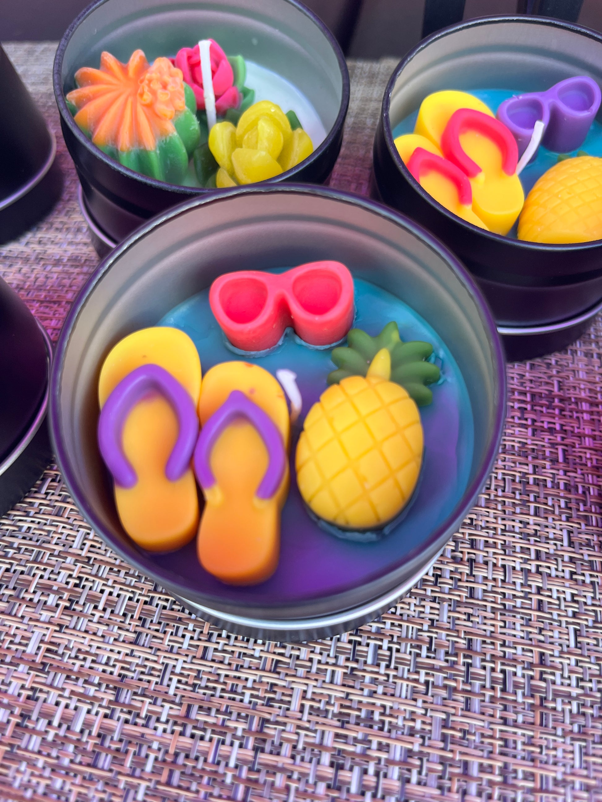 Small WicksNWax sea art tin with blue wax melts, pink tentacle, and pineapple pieces