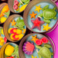 Small round wax melt tin with sea turtle, starfish, and colorful shell shapes