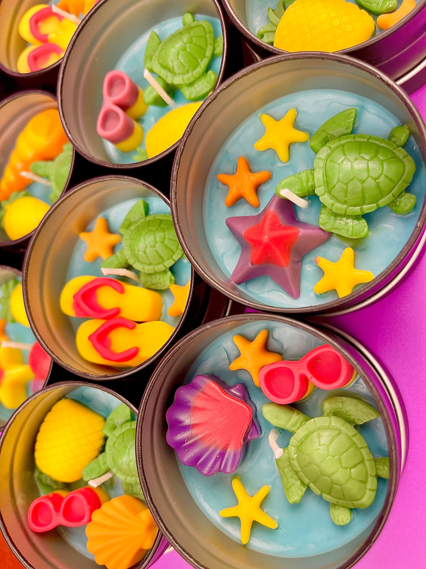 Small round wax melt tin with sea turtle, starfish, and colorful shell shapes