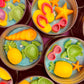 Small sea-themed wax tins with starfish, shells, and green sea turtle pieces in blue wax
