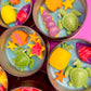 Small sea-themed wax tins with starfish, pink and yellow shells, and green turtles