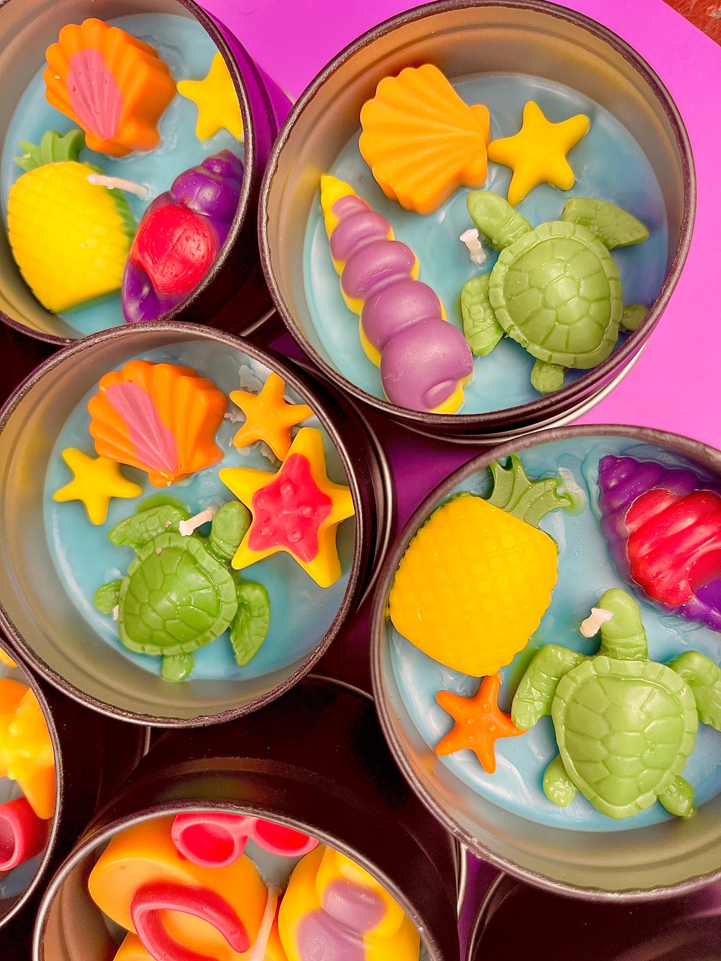 Small sea-themed wax tins with starfish, pink and yellow shells, and green turtles