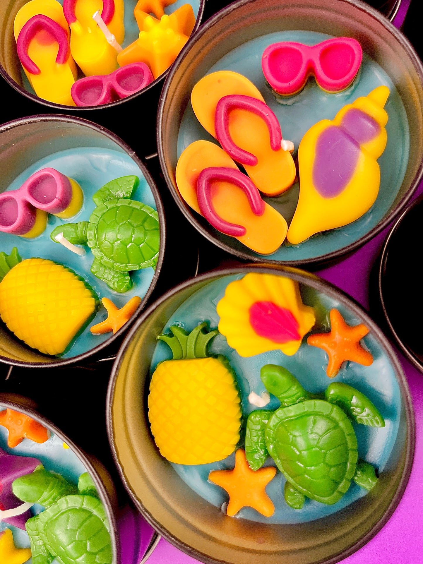 Small sea-themed wax tins with seashells, starfish, and green turtle in blue wax