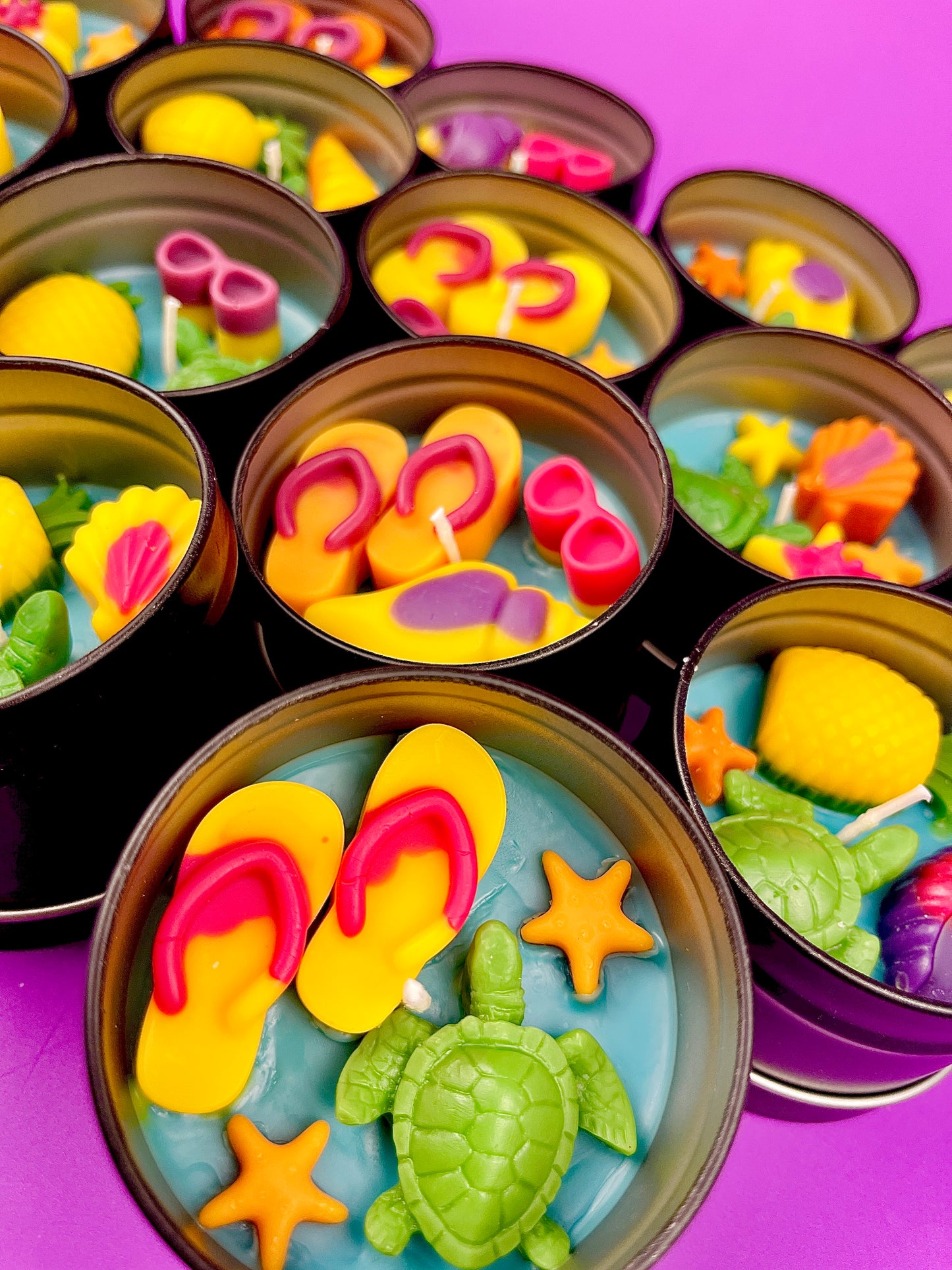 Small sea-themed wax tins with pink coral shapes, starfish, and green sea turtles