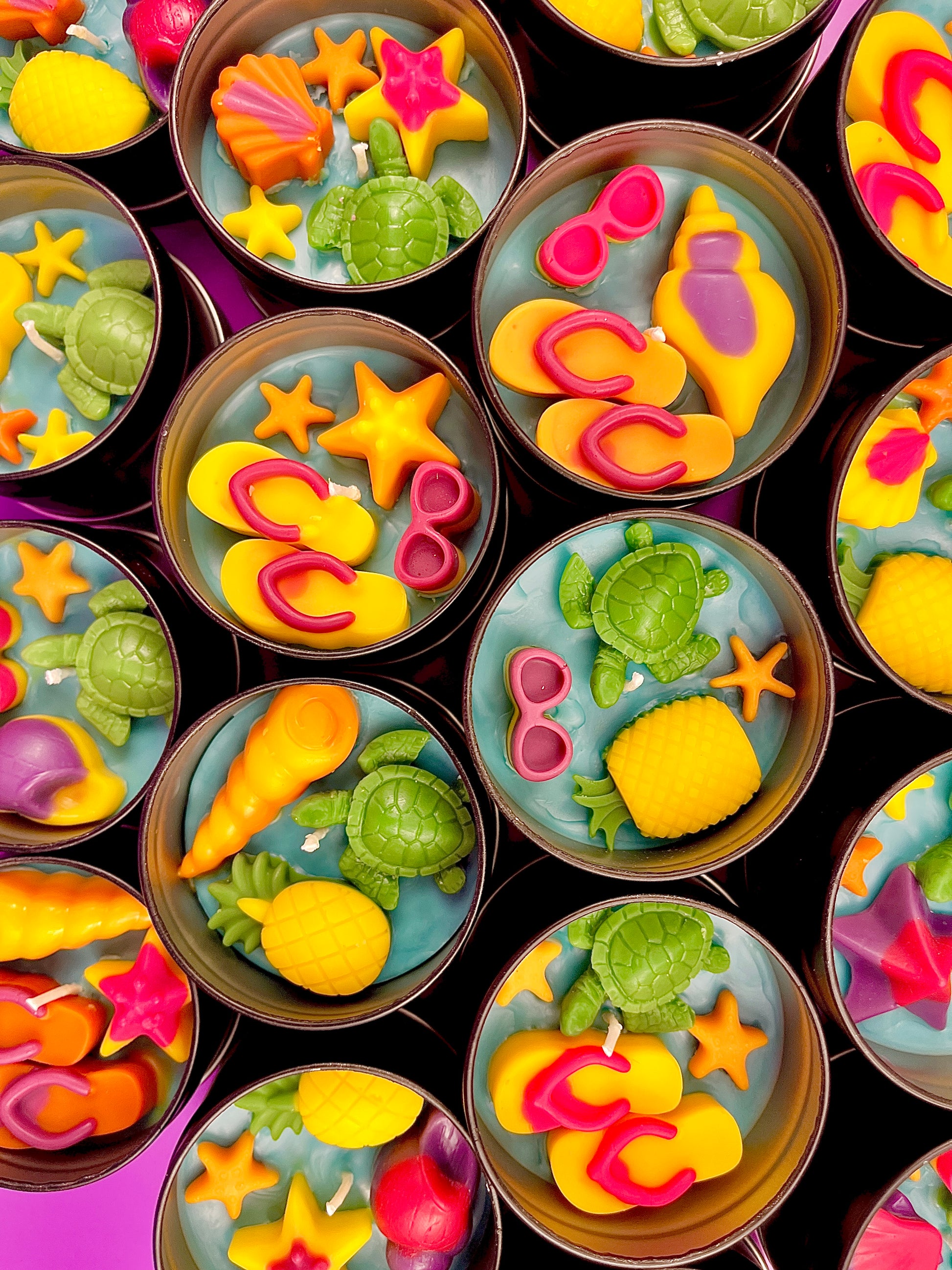 Small sea-themed wax tins filled with starfish, shells, and green sea turtle pieces