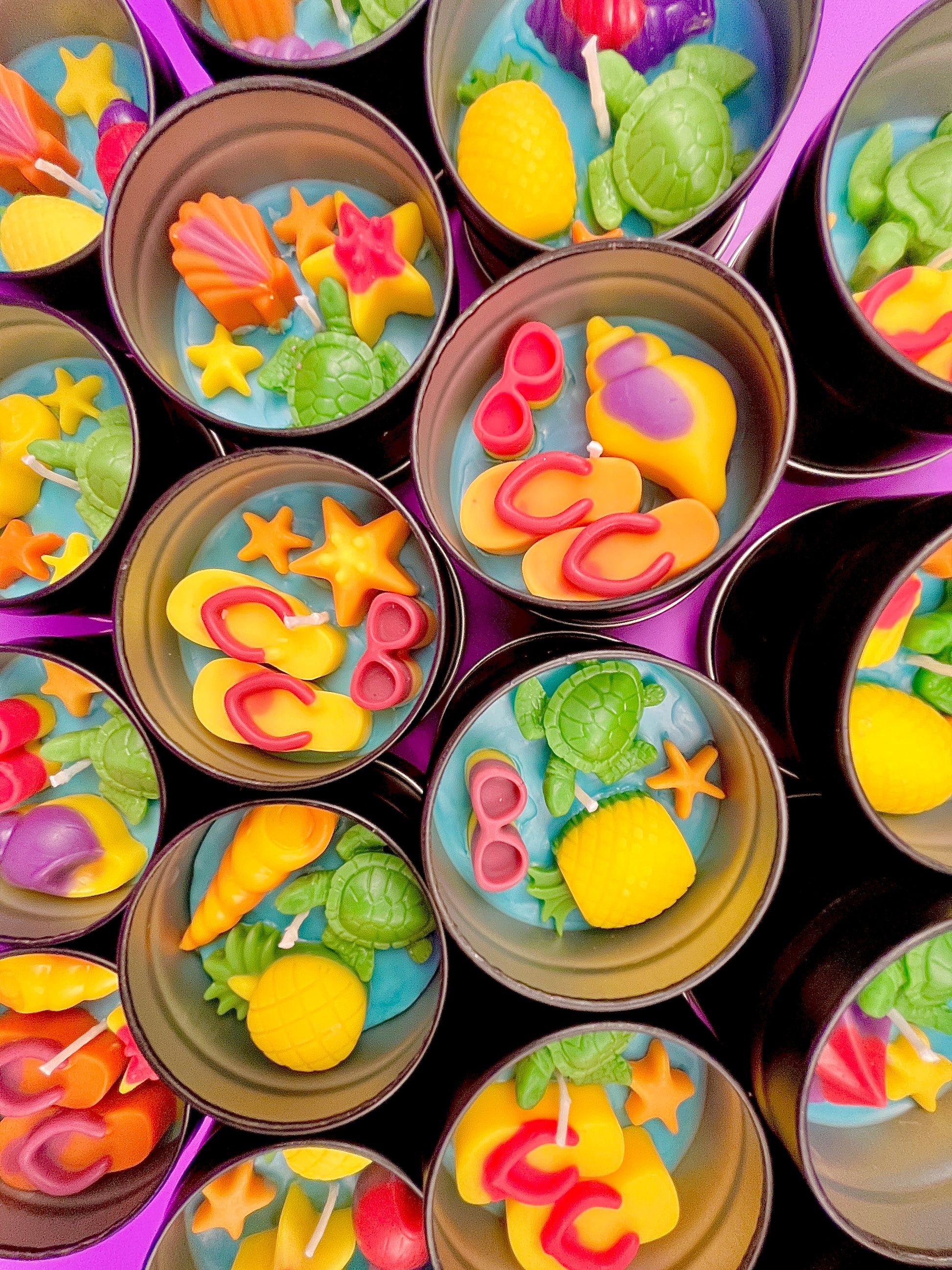 Small round wax melt tins with mixed sea shapes: turtle, starfish, shells in colors