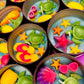 Small WicksNWax sea art tins with green turtle wax, yellow starfish, and red shell pieces