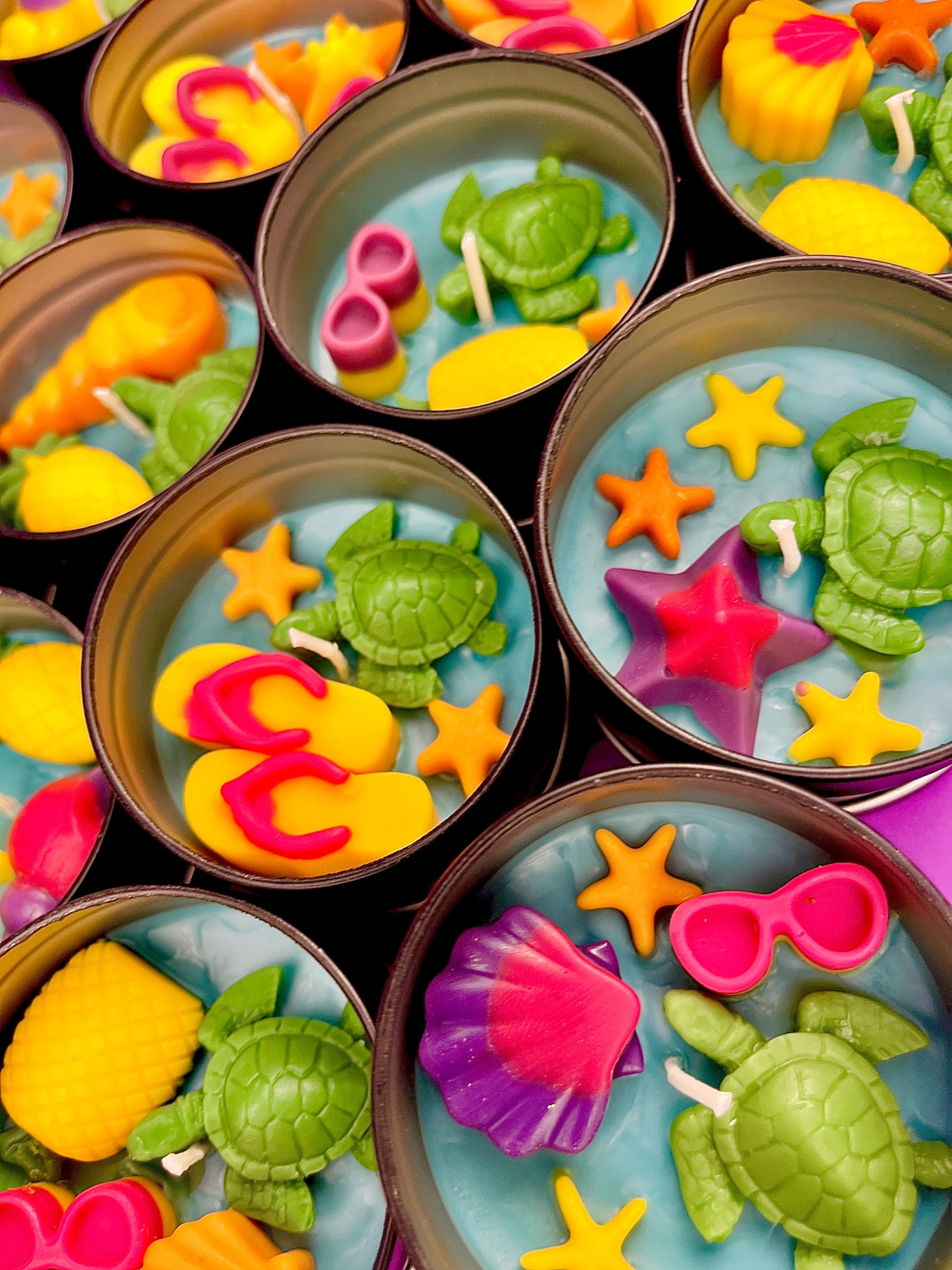 Small WicksNWax sea art tins with green turtle wax, yellow starfish, and red shell pieces