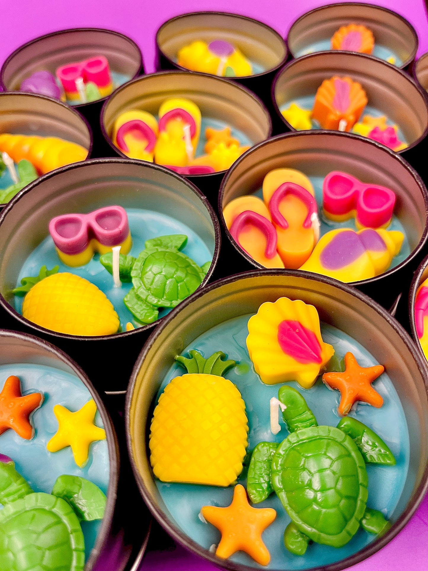 Small WicksNWax sea art tins with blue wax, starfish, turtles, and purple shell shapes
