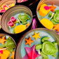 Small round wax melt tin with sea turtle, starfish, and bright seashell shapes