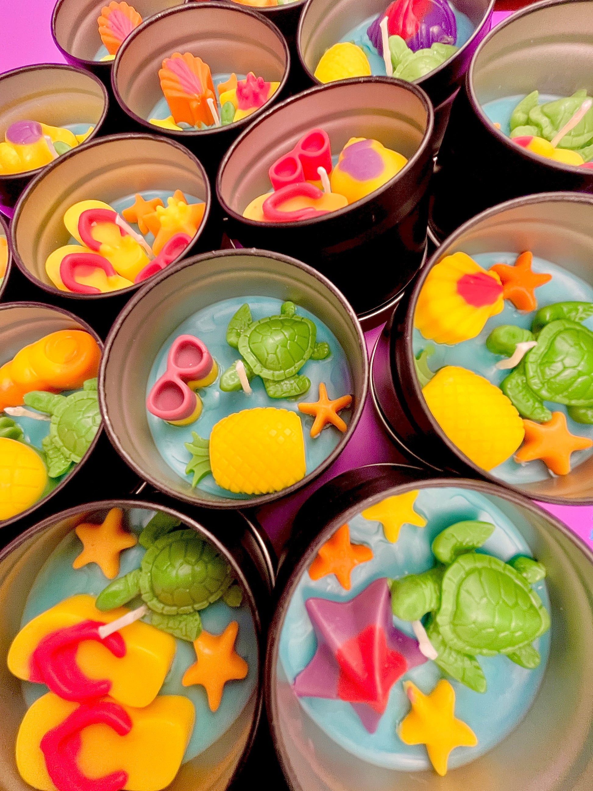 Small sea-themed wax tins with seashells, starfish, and green turtle and lemon shapes
