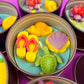 Large metal candle tin with yellow star, purple shell, green turtle, and red accents