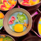 Small round wax melt tin with sea turtle, yellow scallop, starfish, and pink shells