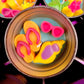 Small round wax melt tin with pink bow shells and orange and yellow sea shapes